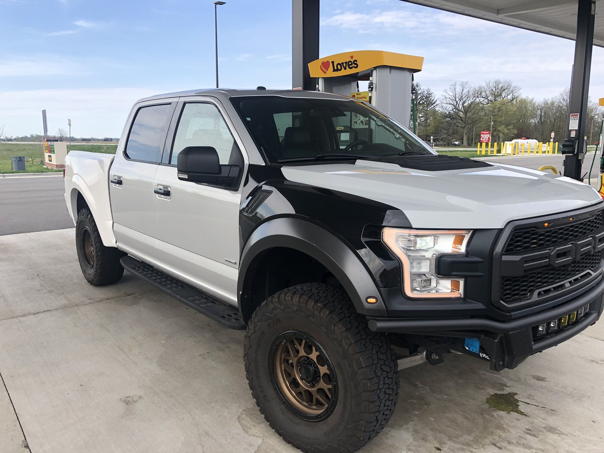 Mid-conversion, before paint — Raptor front end fitted, body panels still mismatched